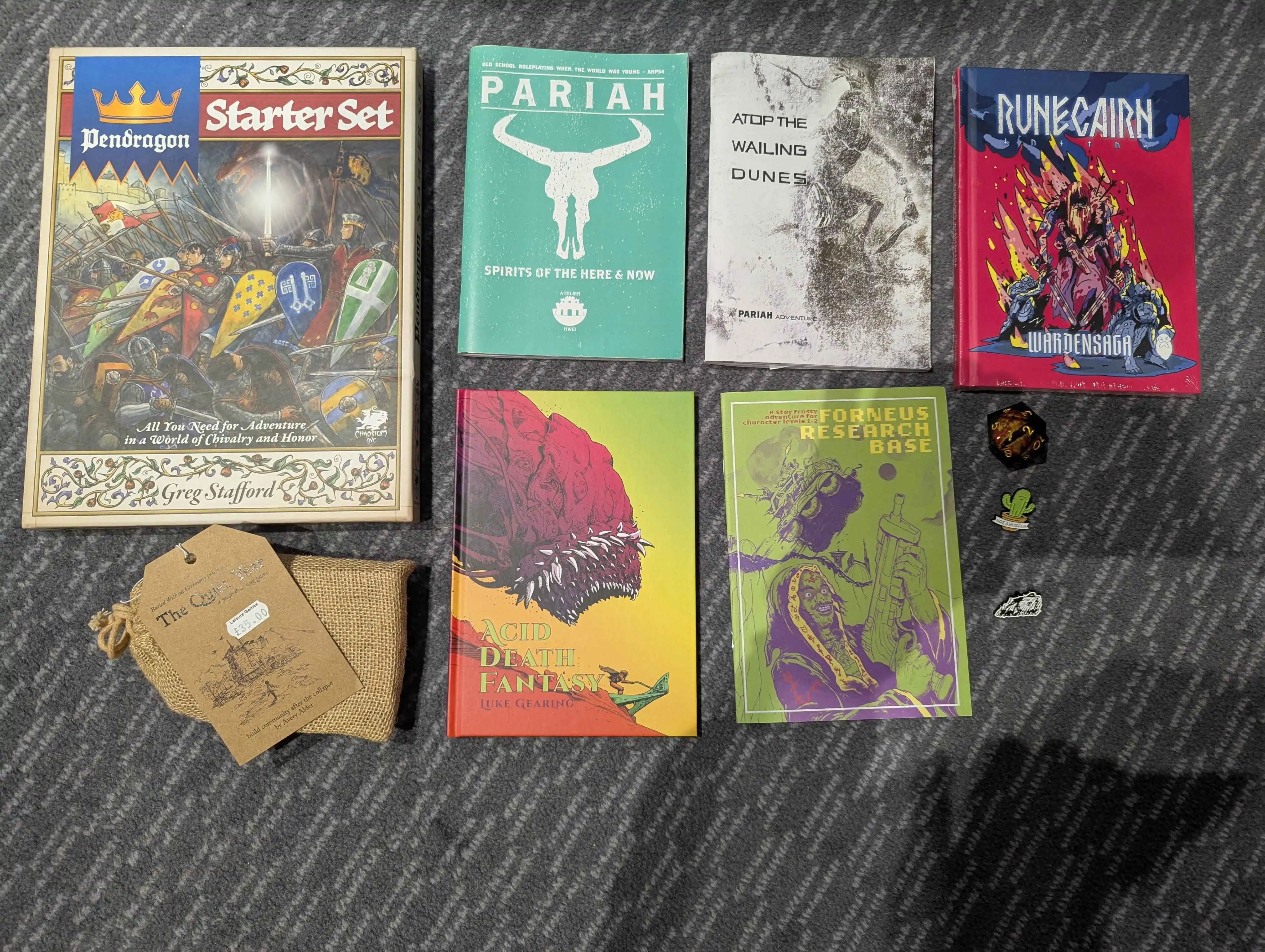 Pile of new RPG books and pins